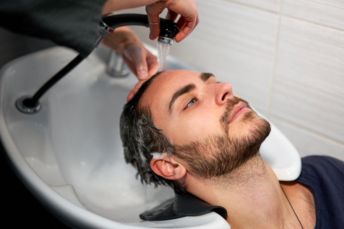 Hairdresser Washing the Hair of Male Client