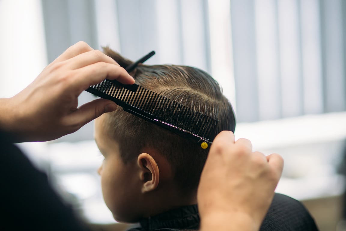 Little Boy Getting Haircut at Barbershop